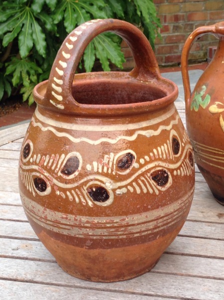 A large bucket-pot with traied slip decoration in white and purple-brown. Some blackening to the base.